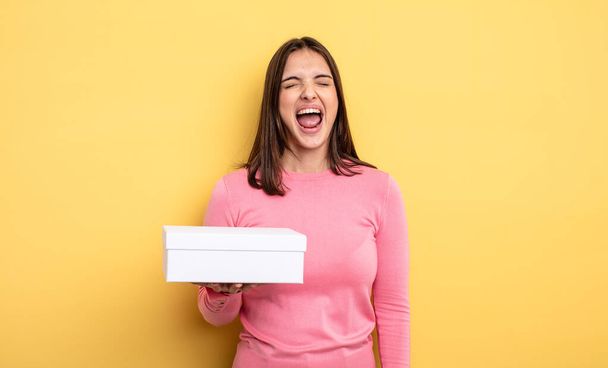 pretty woman shouting aggressively, looking very angry. white box packaging concept - Fotoğraf, Görsel