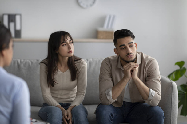Marital psychotherapy. Sad arab spouses with relationship problems sitting at therapy session with psychologist - Photo, image