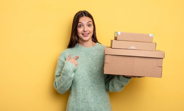 pretty woman feeling happy and pointing to self with an excited packages boxes concept - Zdjęcie, obraz