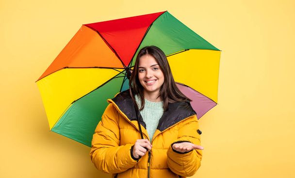 pretty woman smiling happily with friendly and  offering and showing a concept. winter and umbrella concept - Foto, Imagem