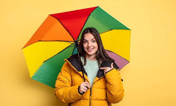 pretty woman feeling happy and pointing to self with an excited. winter and umbrella concept - 写真・画像