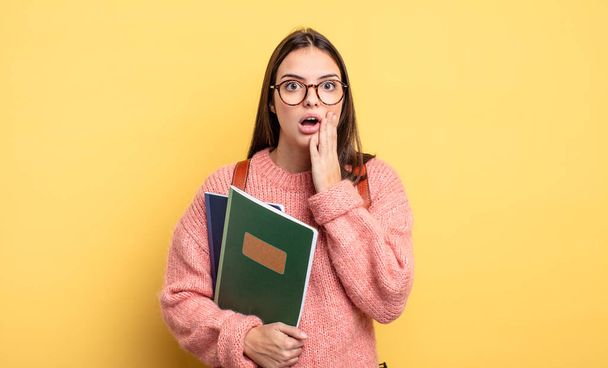 pretty student woman feeling shocked and scared - Фото, изображение