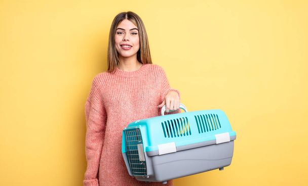 pretty woman looking happy and pleasantly surprised. pet carrier concept - Foto, Imagen