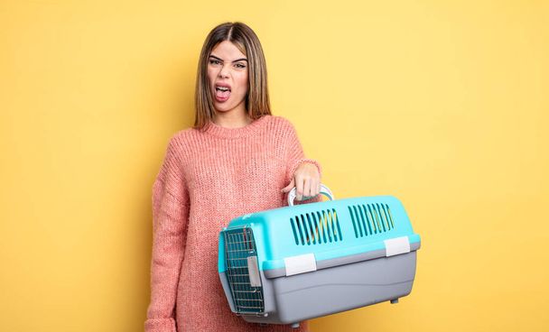 pretty woman feeling disgusted and irritated and tongue out. pet carrier concept - Foto, Imagen
