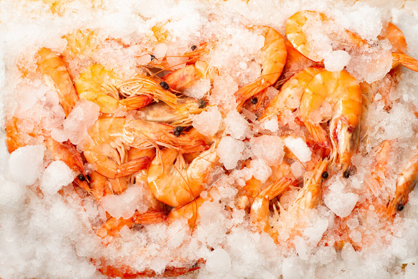 Shrimp covered with ice in a shop window. Frozen food - Foto, Imagen