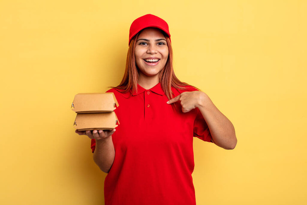 hispanic woman feeling happy and pointing to self with an excited. take away deliver concept - Φωτογραφία, εικόνα