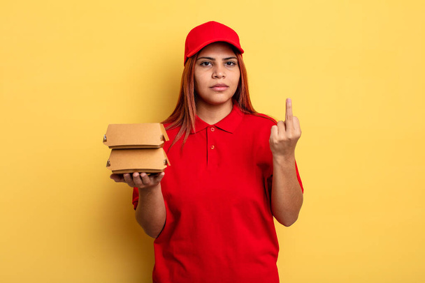hispanic woman feeling angry, annoyed, rebellious and aggressive. take away deliver concept - Photo, image