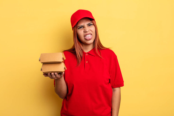 hispanic woman feeling disgusted and irritated and tongue out. take away deliver concept - Foto, Bild