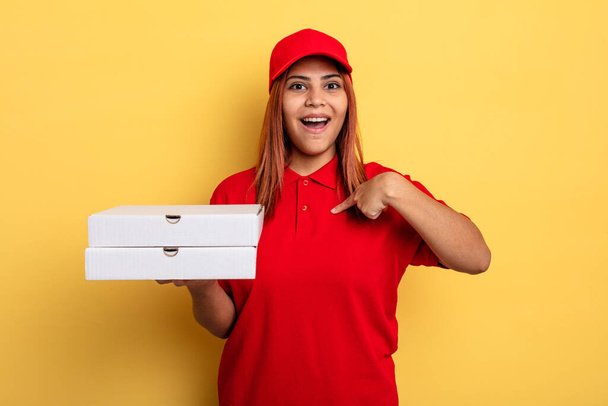 hispanic woman feeling happy and pointing to self with an excited. take away deliver concept - Fotó, kép