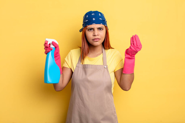 hispanic woman making capice or money gesture, telling you to pay. cleaning and housekeeper concept - Foto, imagen