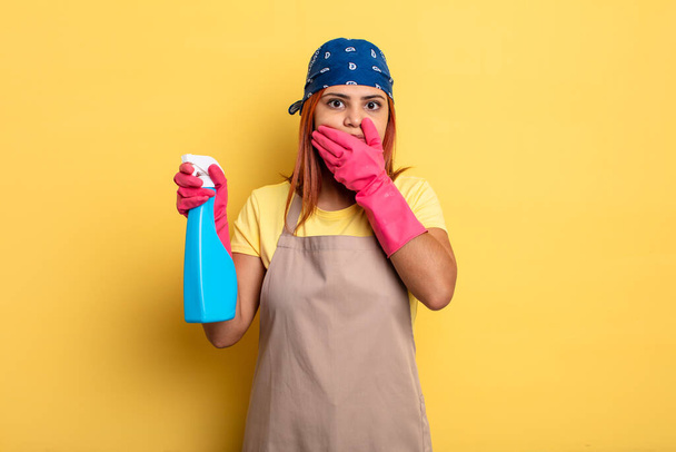 hispanic woman covering mouth with hands with a shocked. cleaning and housekeeper concept - Valokuva, kuva