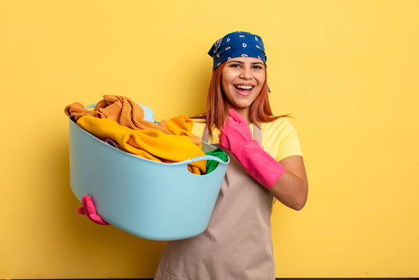 housekeeper feeling happy and facing a challenge or celebrating. washing clothes concept - Photo, image
