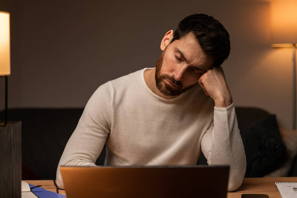 Workaholism, working on laptop. Tired stressed businessman having fatigue depression, job troubles, headache and migraine  - Fotó, kép