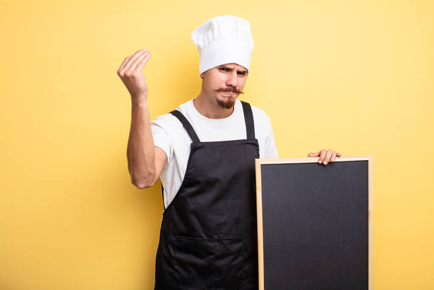 chef man making capice or money gesture, telling you to pay - Foto, imagen