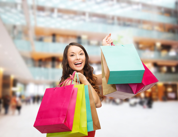smiling woman with colorful shopping bags - Foto, Imagem
