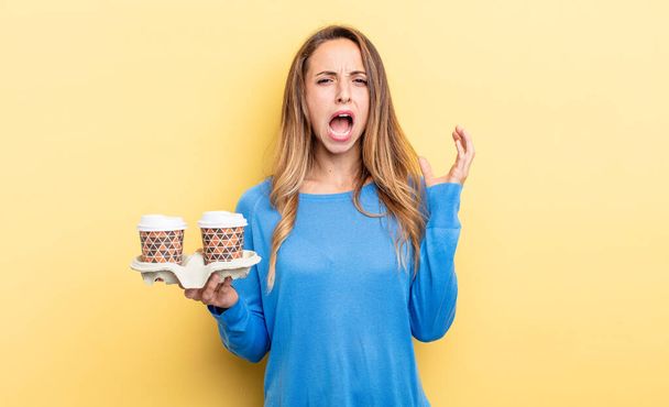 pretty woman screaming with hands up in the air. take away coffee concept - Foto, Imagen