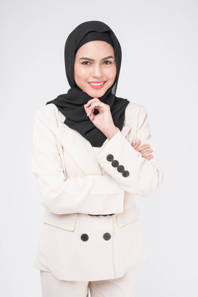 Portrait of young smiling muslim businesswoman wearing suit with hijab over white background studio.	 - Fotoğraf, Görsel