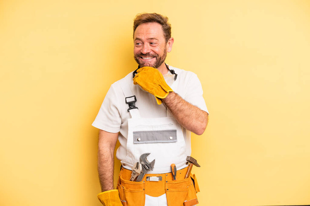 middle age man smiling with a happy, confident expression with hand on chin. handyman and repair concept - Fotografie, Obrázek