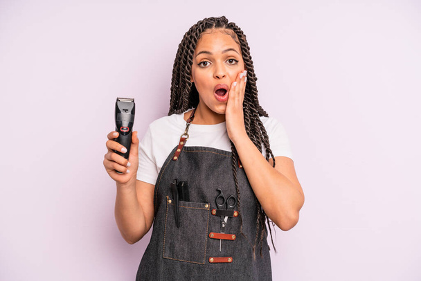 black afro woman feeling shocked and scared. barber shop concept - Valokuva, kuva