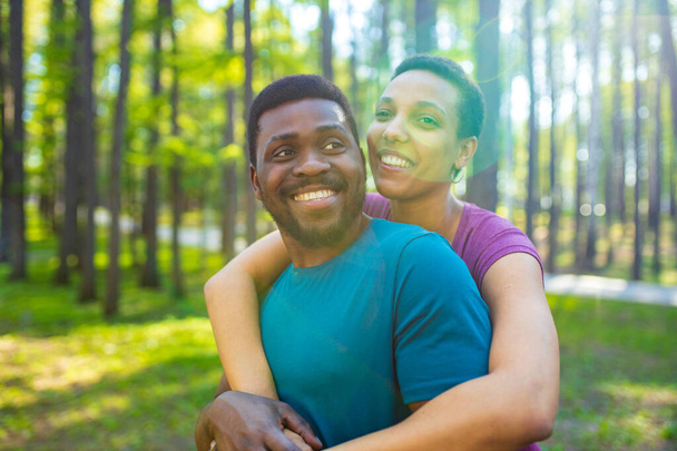 african american couple talking together in summer park - Фото, зображення