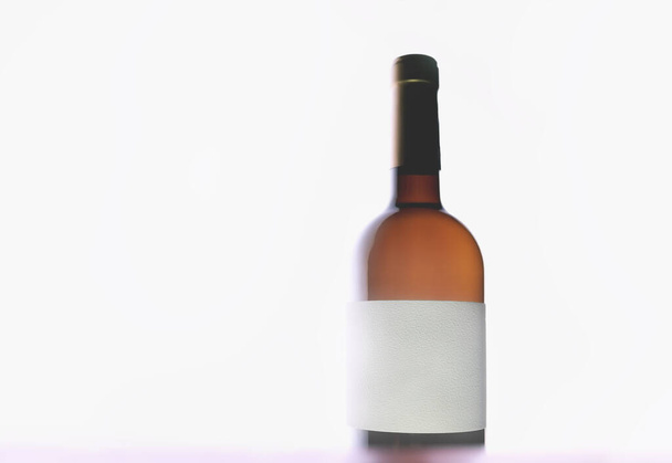 Bottle of wine with blank label. Unlabeled wine bottle. No Name Wine on white background. Bottle without a name on the label. Blank white label. Back lighting. - Photo, Image