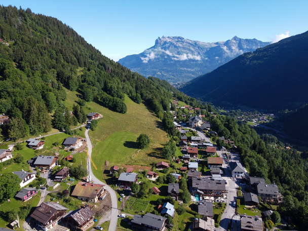 Panoramic view on mountain villages, green forests and apline meadows near Saint-Gervais-les-Bains, Savoy, France in summer - Photo, Image