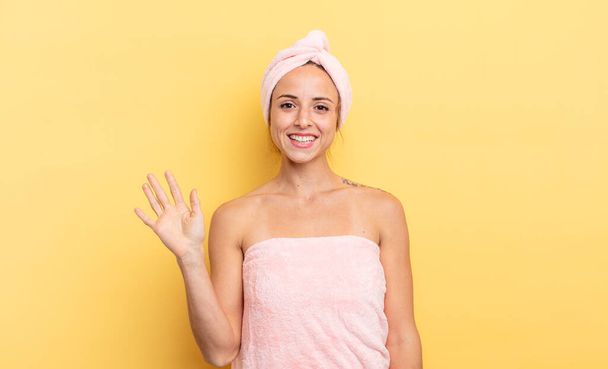 pretty woman smiling happily, waving hand, welcoming and greeting you. shower and beauty concept - Foto, afbeelding