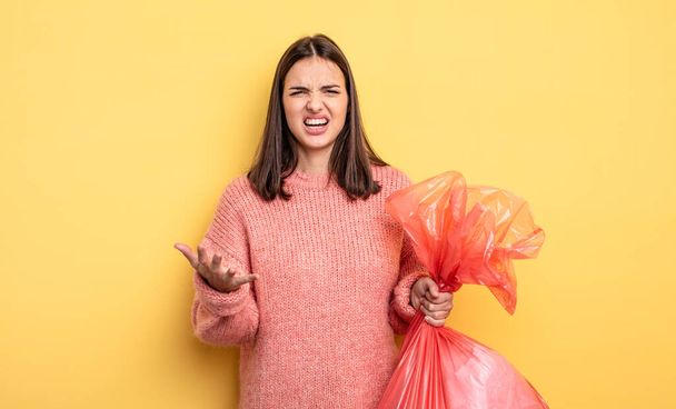 pretty woman looking angry, annoyed and frustrated. trash bag concept - Fotoğraf, Görsel