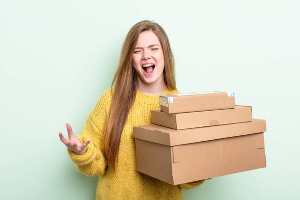 red hair woman looking angry, annoyed and frustrated. packages boxes concept - Fotografie, Obrázek