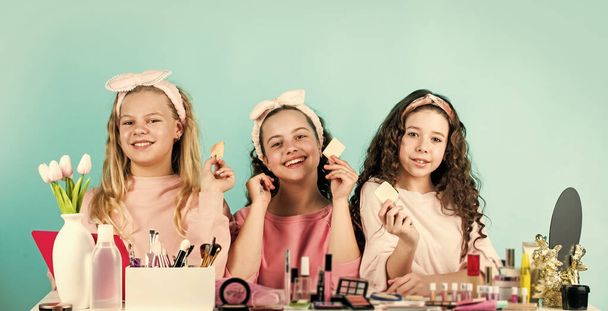 Cosmetics shop. Girls only. Skin care concept. Cosmetics for children. Beauty and fashion. Happy girls doing makeup together. Childhood happiness. Kids makeup. Sisterhood happiness. Happy womens day - Zdjęcie, obraz