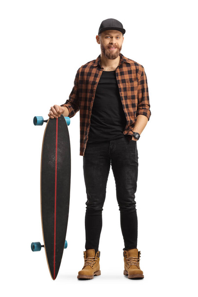 Full length portrait of a young man posing with a longboard isolated on white background     - Foto, immagini
