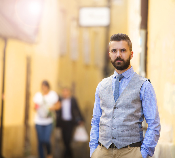 Businessman with beard walking in town - Фото, изображение