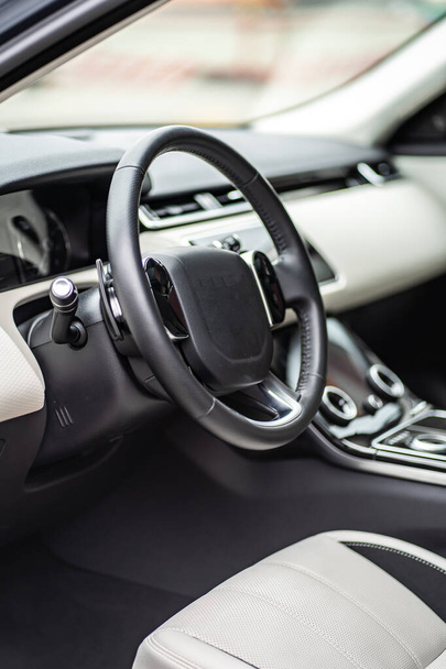 Modern luxury prestige car interior, dashboard, steering wheel. Orange red perforated leather interior. - Fotó, kép