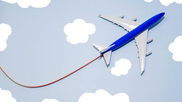 Copy space Airplane in flight on a blue background, airplane flight trajectory, passenger airplane is flying in the sky top view - Φωτογραφία, εικόνα