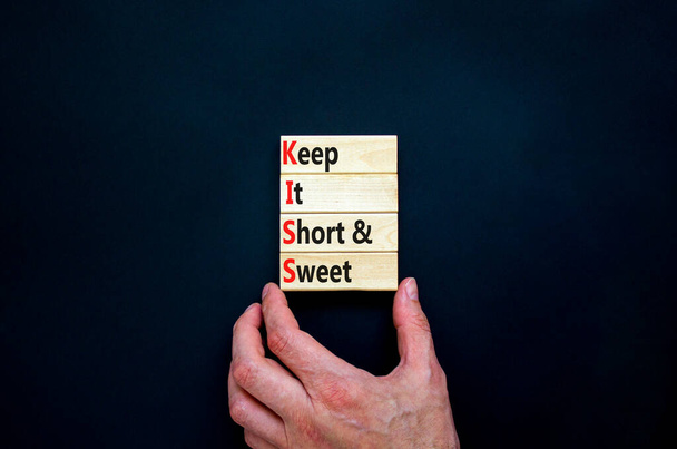 KISS keep it short and sweet symbol. Concept words KISS keep it short and sweet wooden blocks. Beautiful black table, black background. Business and KISS keep it short and sweet concept. Copy space. - Photo, Image