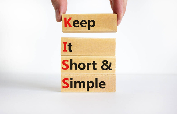 KISS keep it short and simple symbol. Concept words KISS keep it short and simple wooden blocks. Beautiful white table, white background. Business KISS keep it short and simple concept. Copy space. - Photo, Image