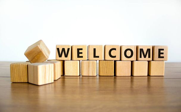Welcome and support symbol. The concept word Welcome on wooden cubes. Beautiful wooden table, white background, copy space. Business, welcome and support concept. - Fotoğraf, Görsel