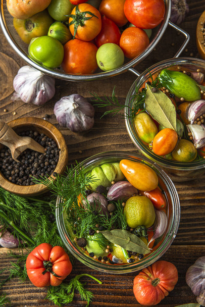 Pickled Tomatoes in Jar with Herbs and Garlic. - Fotó, kép