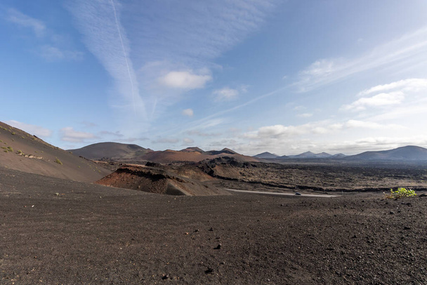 Timanfaya national park a vulcanic landscape surrounded by and mountains and vulcanicn rocks , at Lanzarote, Canary islands. Spain. - Zdjęcie, obraz