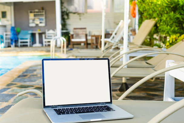 laptop on a sun lounger by the pool - Photo, Image