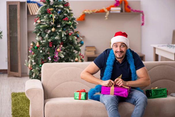 Young man celebrating Christmas at home - Photo, Image