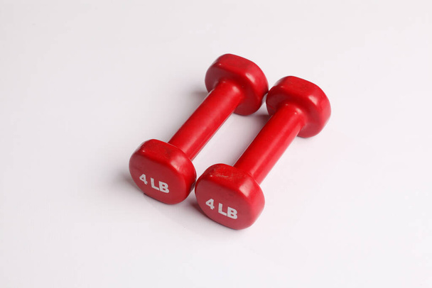 Two red dumbbells isolated on white background - Photo, Image