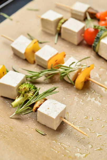 Baking tray with grilled tofu cheese skewers on table, closeup - Photo, Image