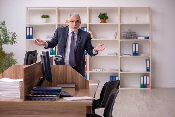 Old male employer and too much work in the office - 写真・画像
