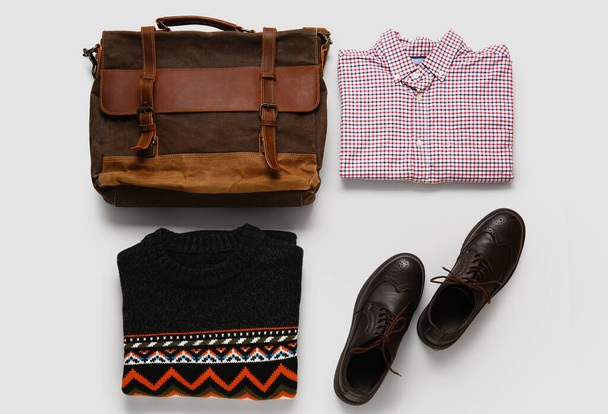 Male clothes, bag and shoes on light background - Zdjęcie, obraz