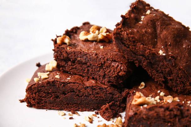 Plate with pieces of tasty chocolate brownie on table, closeup - Foto, immagini