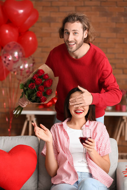 Man greeting his girlfriend on Valentine's Day at home - Fotó, kép