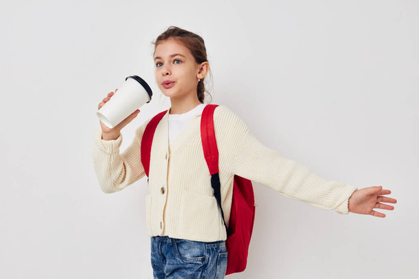 little girl hand gesture red backpack light background - Фото, изображение