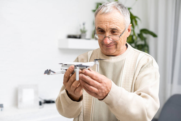 elderly man with small model airplane - Photo, Image