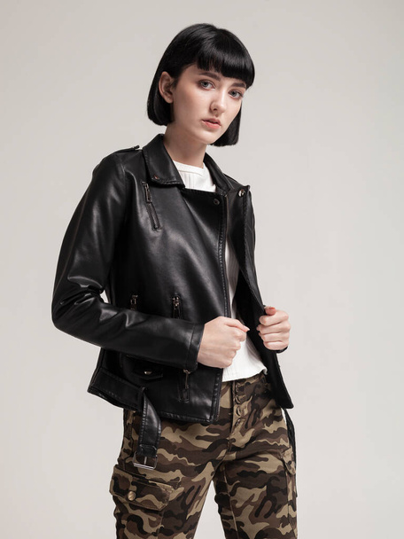 fashionable girl in black leather jacket and pants in military style - Zdjęcie, obraz